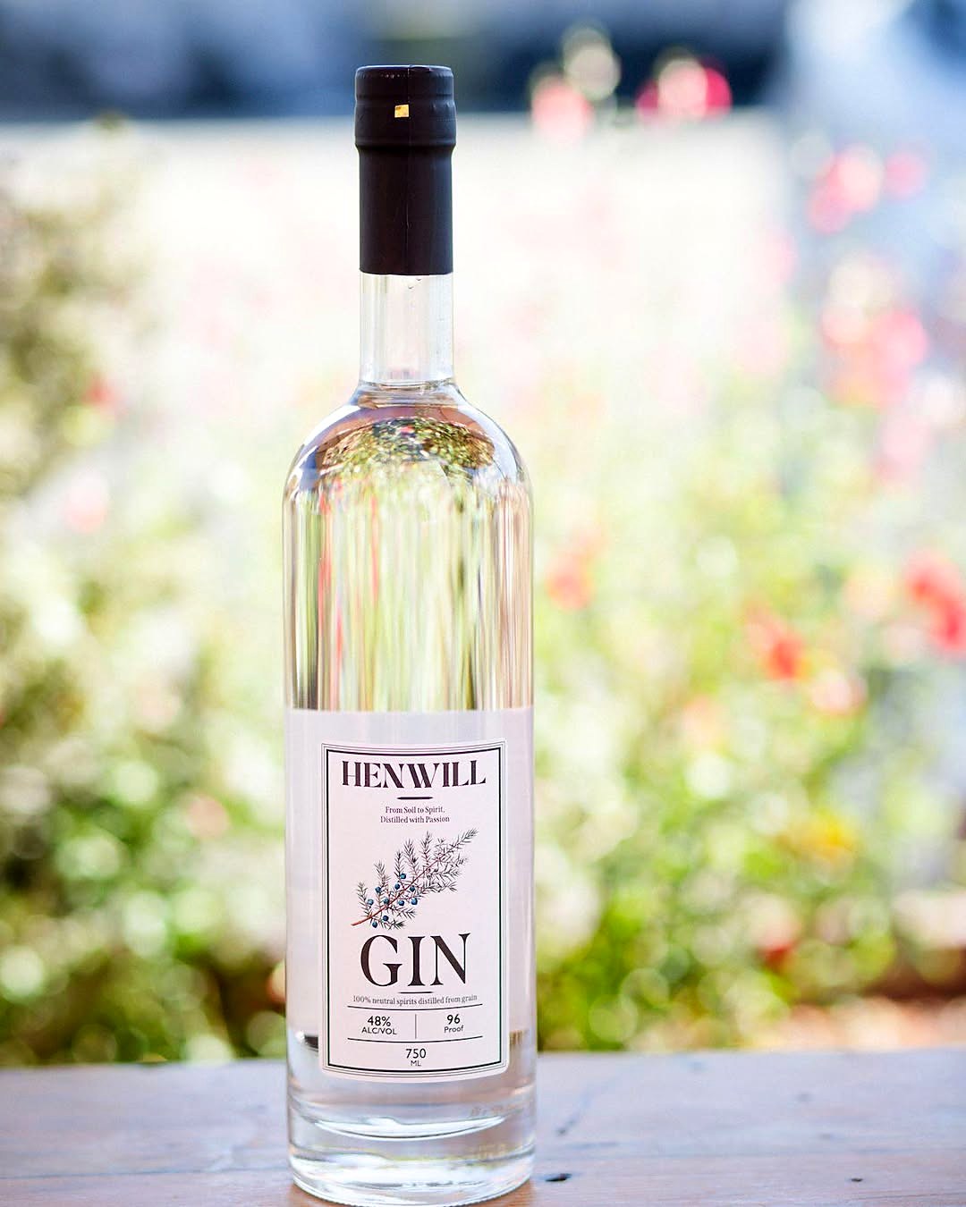 Henwill Gin bottle in California wildflowers