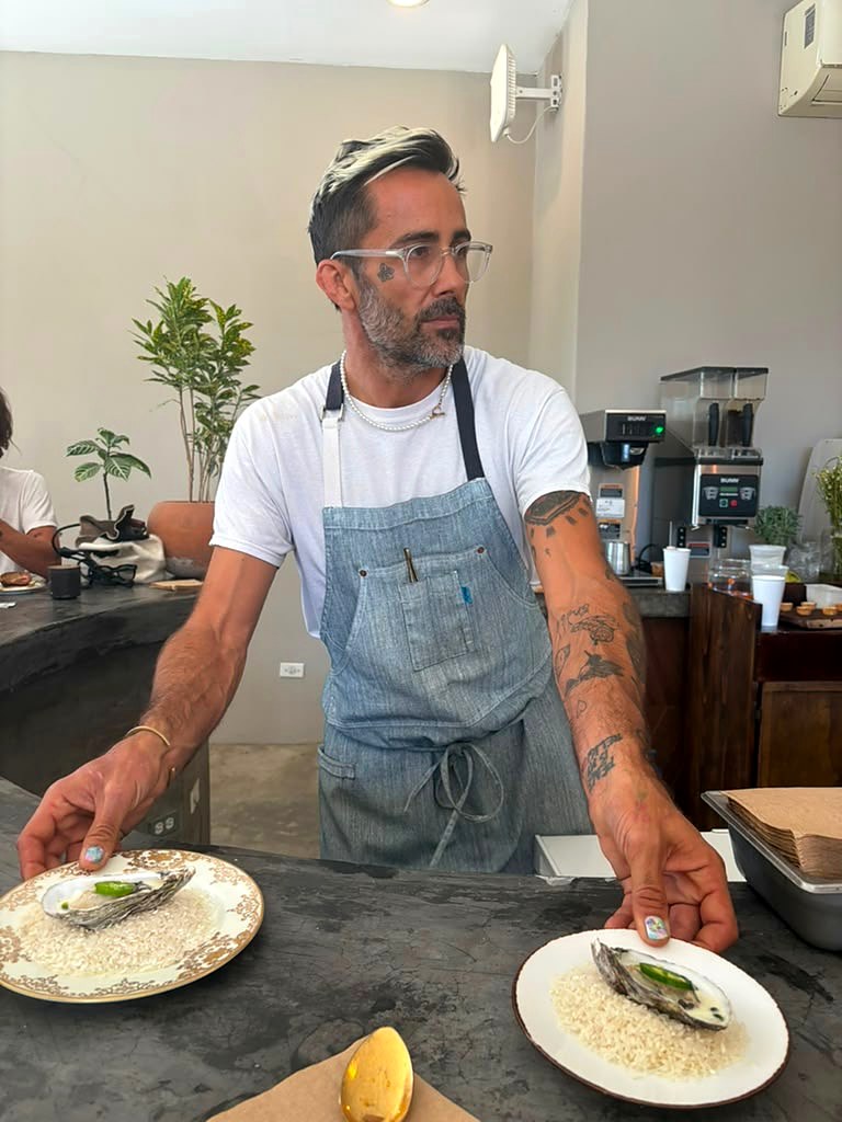 Chef Paul Barbosa plating oysters at the counter