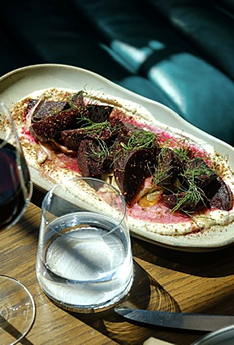 Plated course from Chef Paula Endara: roasted beets with dill over whipped labneh