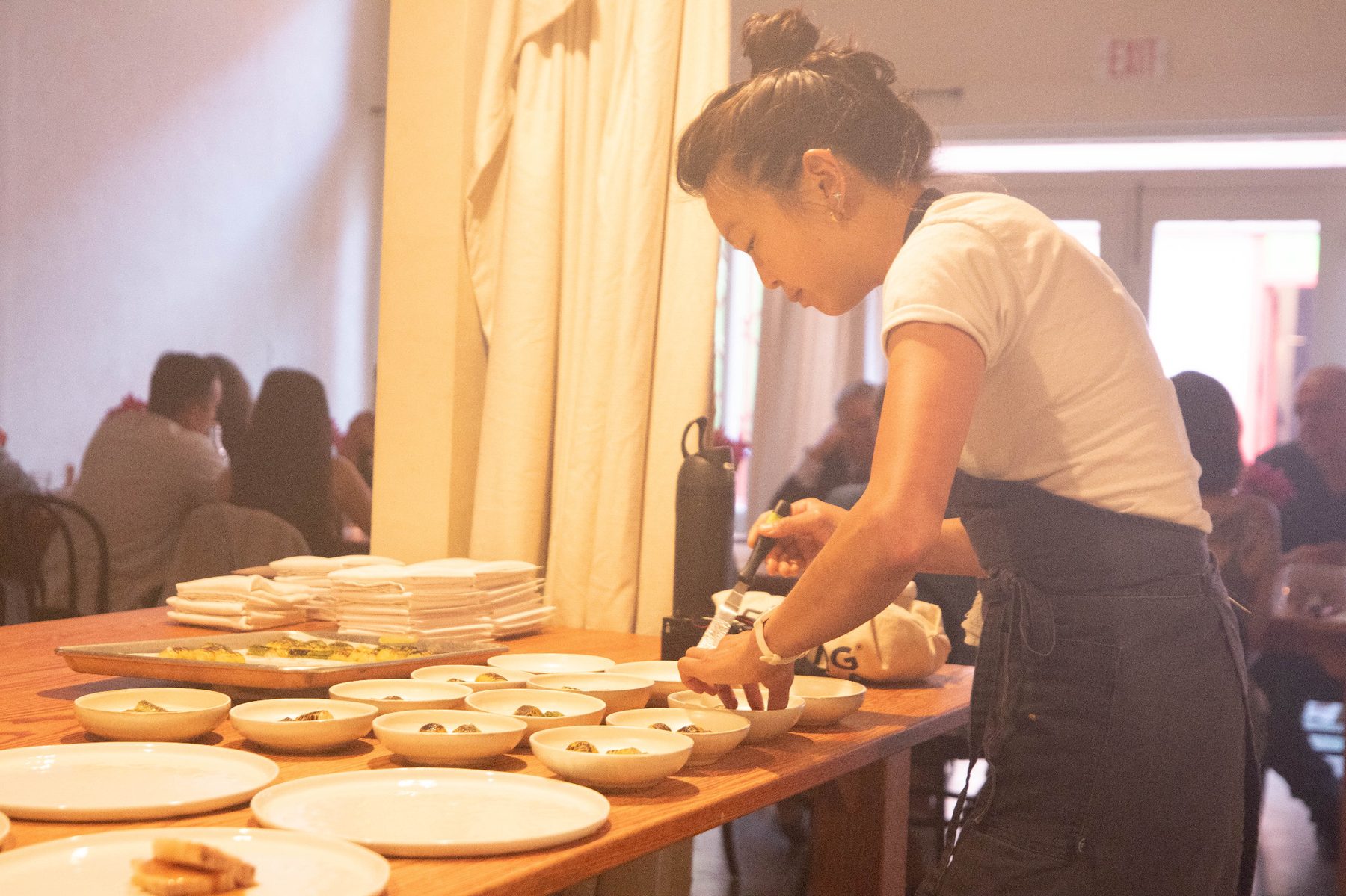 Chefs plating dishes during the Henwill tasting dinner