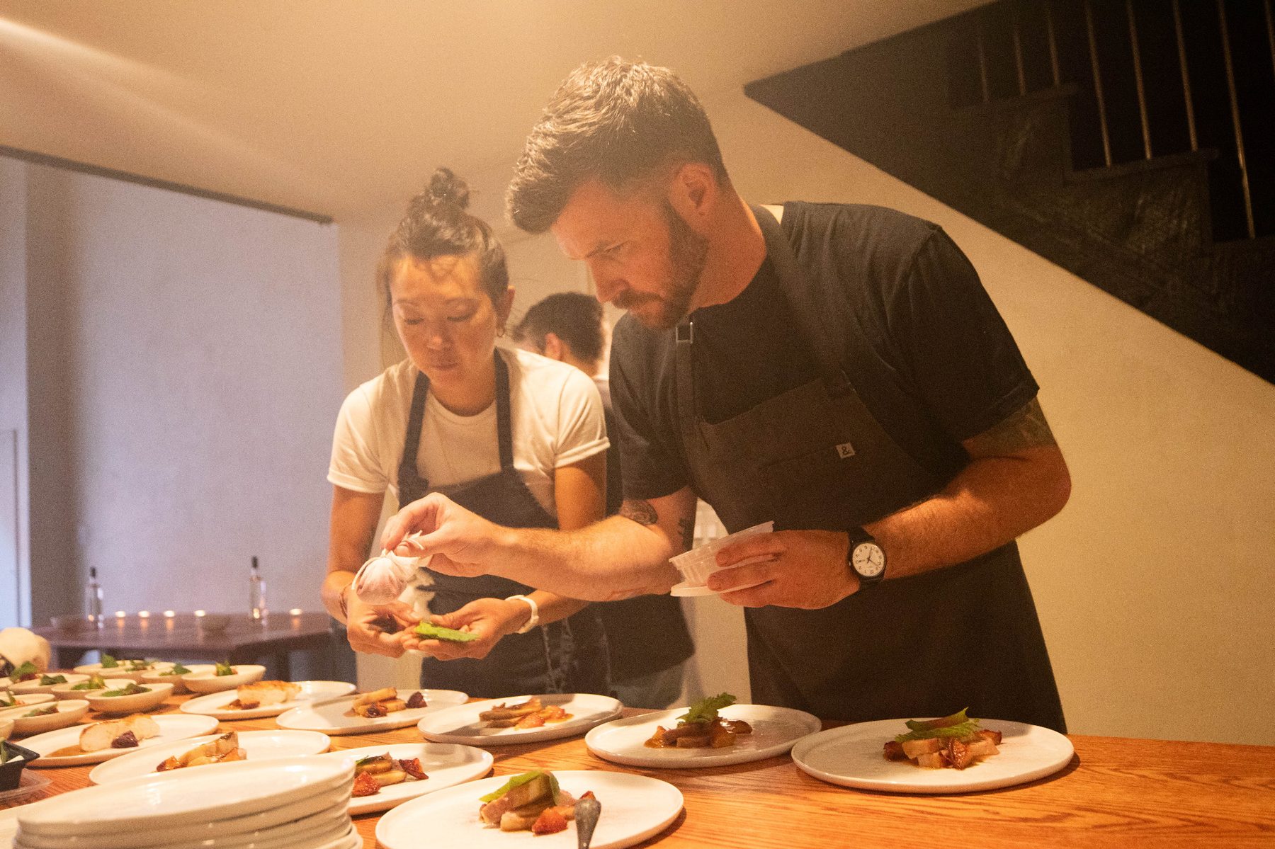 Chefs adding final garnish during service