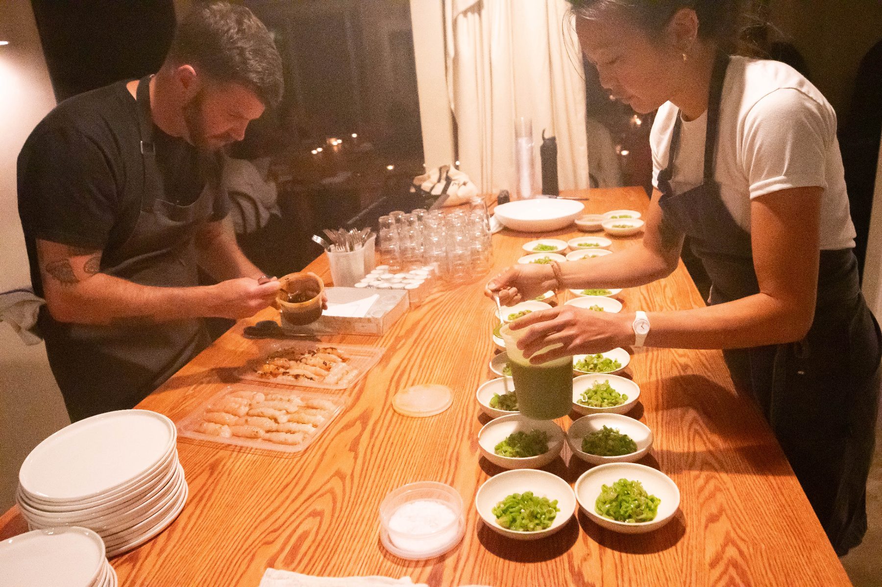 Chefs preparing bowls and seafood for the tasting menu